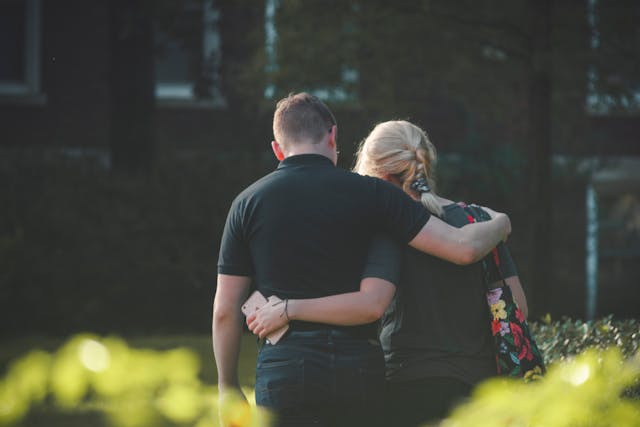 Couple walking toward building Photo by Stanley Morales: https://www.pexels.com/photo/couple-walking-toward-building-1487076/