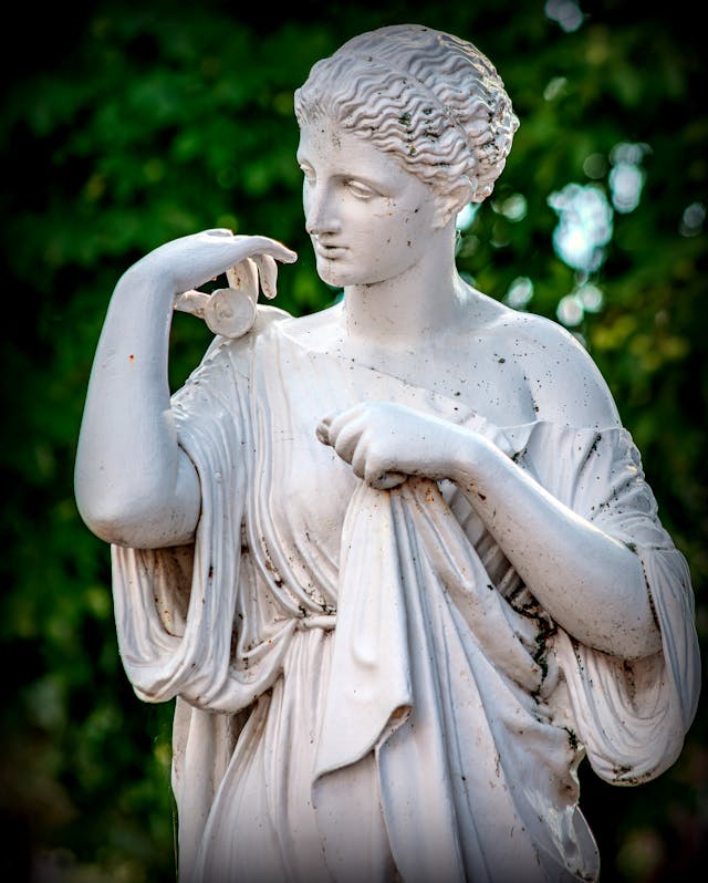 Stone angel Photo by Jean Marc Bonnel: https://www.pexels.com/photo/elegant-marble-statue-in-outdoor-setting-28883864/